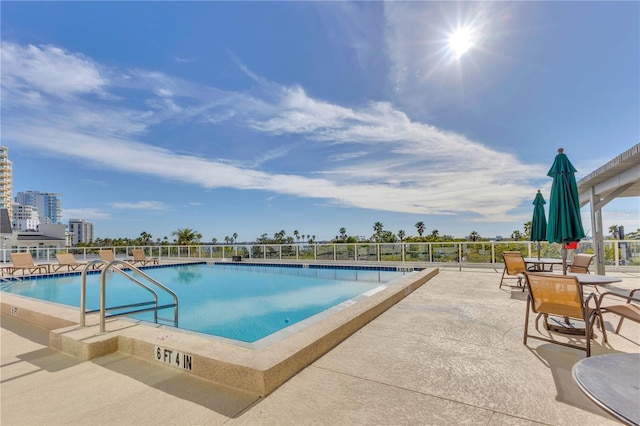 view of swimming pool with a patio