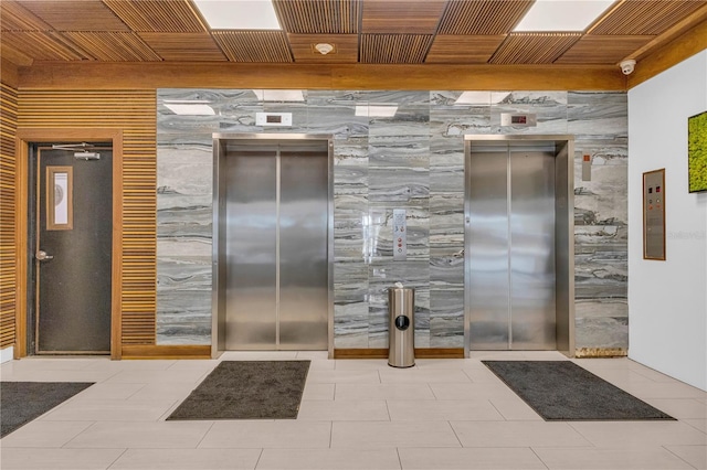 interior space featuring elevator and wood ceiling