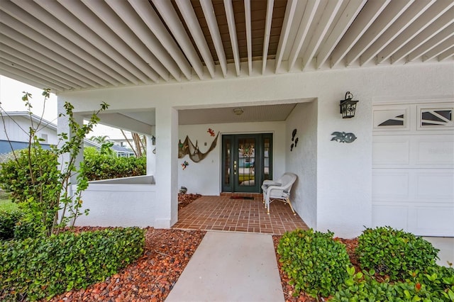 property entrance with a garage and a porch