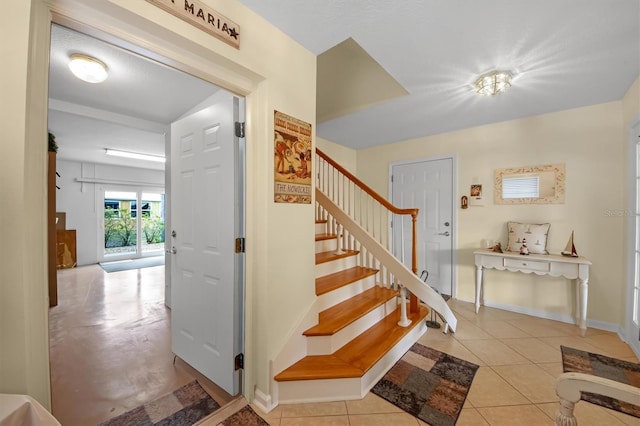 stairs featuring tile patterned floors