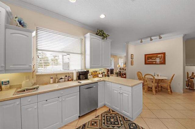 kitchen with dishwasher, ornamental molding, light tile patterned floors, and white cabinets