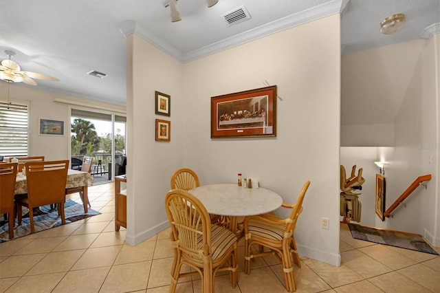 dining space featuring crown molding, light tile patterned floors, and ceiling fan