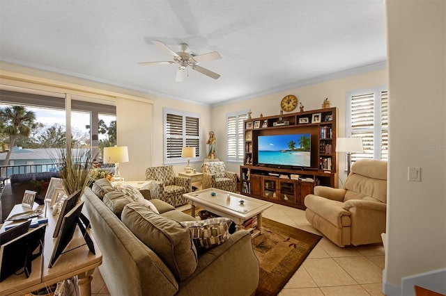 living room with crown molding, light tile patterned floors, and ceiling fan