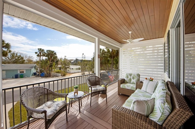 sunroom featuring a wealth of natural light, wooden ceiling, and ceiling fan