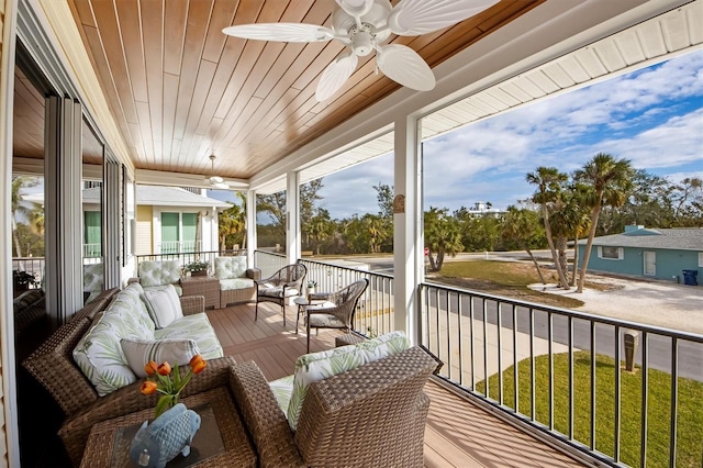 sunroom featuring wooden ceiling and ceiling fan