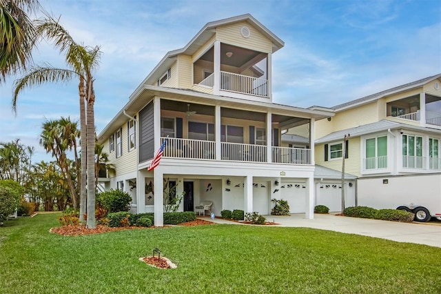 view of front of house with a garage, a balcony, and a front yard