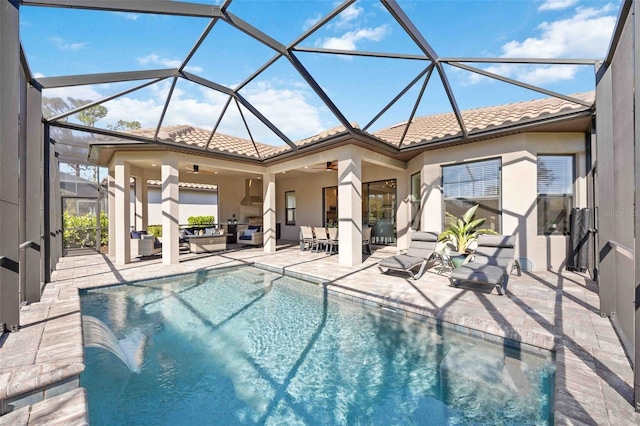 view of pool featuring outdoor lounge area, ceiling fan, a lanai, and a patio area