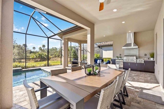 exterior space featuring ceiling fan, a patio, glass enclosure, grilling area, and exterior kitchen