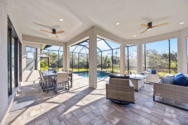 sunroom featuring ceiling fan