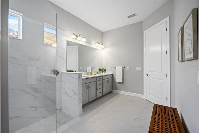 bathroom featuring vanity and tiled shower