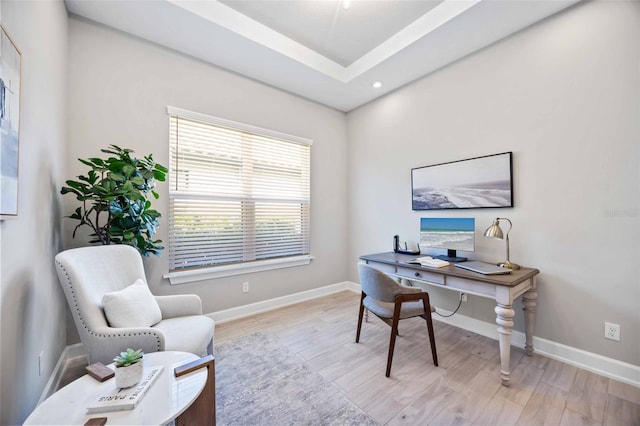 home office with light hardwood / wood-style flooring