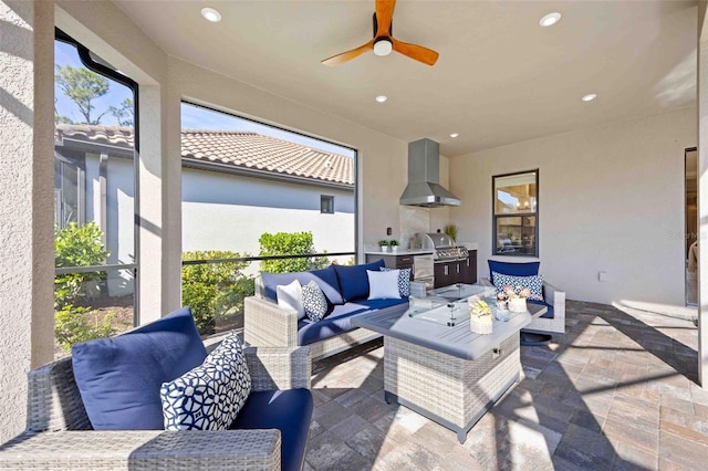 view of patio / terrace featuring grilling area, an outdoor hangout area, ceiling fan, and exterior kitchen