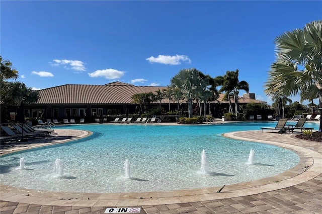 view of swimming pool with pool water feature