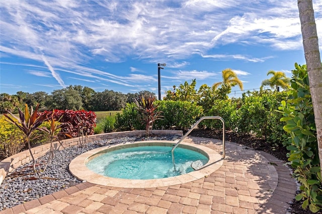 view of swimming pool featuring an in ground hot tub and a patio