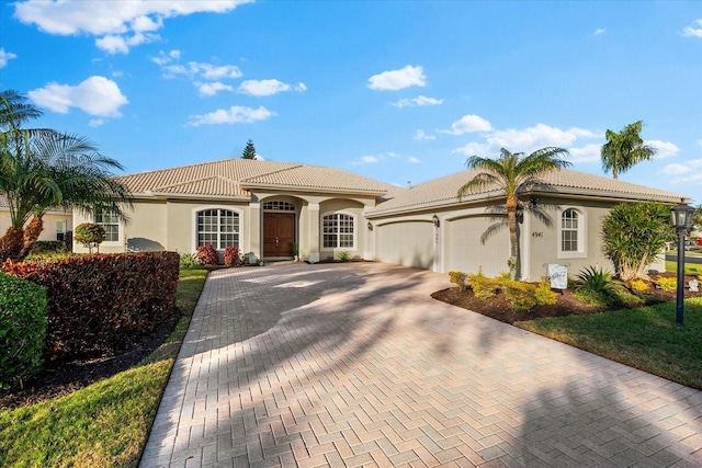 mediterranean / spanish-style house with a garage