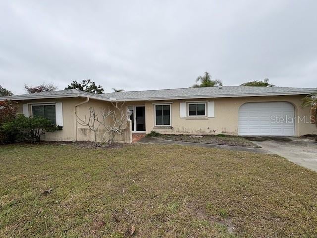 single story home featuring a front lawn, an attached garage, driveway, and stucco siding