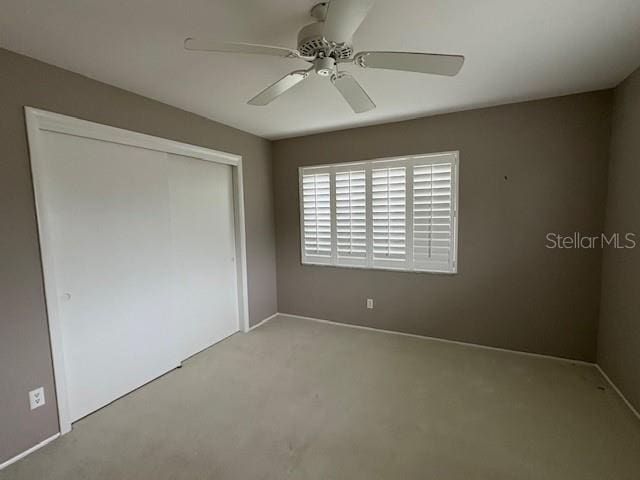 unfurnished bedroom featuring a closet and ceiling fan