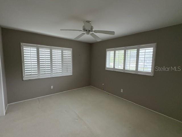 unfurnished room with a ceiling fan