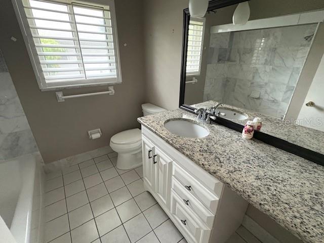 bathroom featuring vanity, tile patterned floors, toilet, and walk in shower