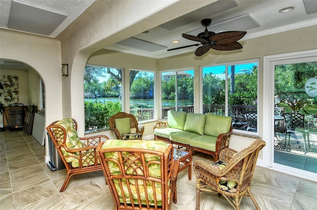 sunroom / solarium featuring ceiling fan