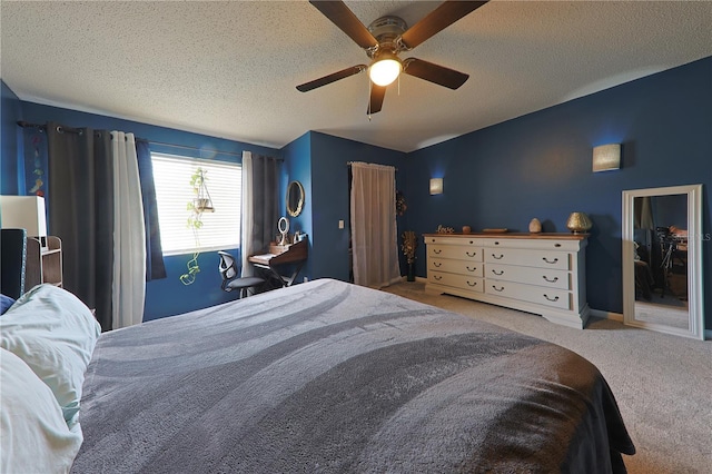 carpeted bedroom with ceiling fan and a textured ceiling