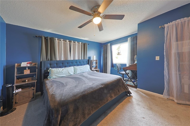 carpeted bedroom featuring ceiling fan and a textured ceiling