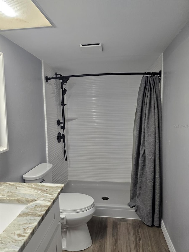 2566 Forest Run Ct, Clearwater, FL 33761 - full bath featuring vanity, toilet, a stall shower, and wood finished floors