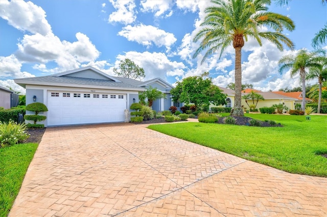 view of front of property featuring a garage and a front lawn