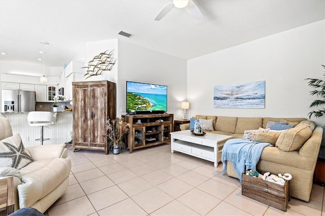 living area with visible vents, ceiling fan, a textured ceiling, and light tile patterned floors