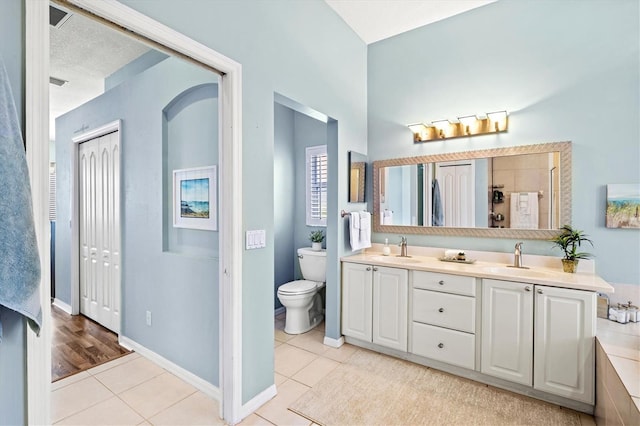 bathroom with double vanity, tile patterned flooring, and a sink