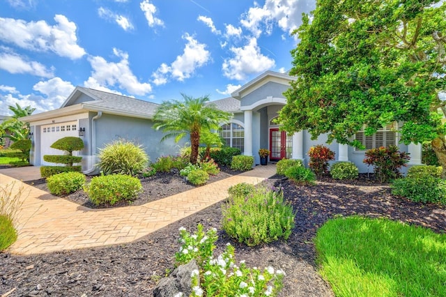 view of front of house featuring a garage and stucco siding