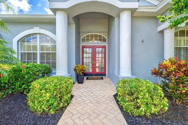 entrance to property with french doors and stucco siding