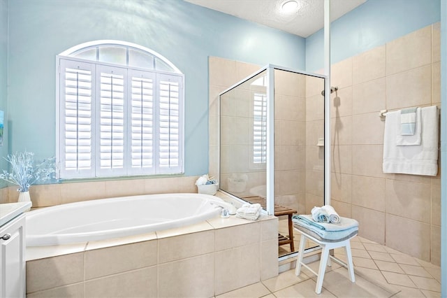 full bath featuring a garden tub, tile patterned flooring, walk in shower, and a textured ceiling