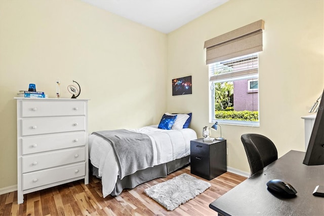 bedroom with light wood-style floors and baseboards