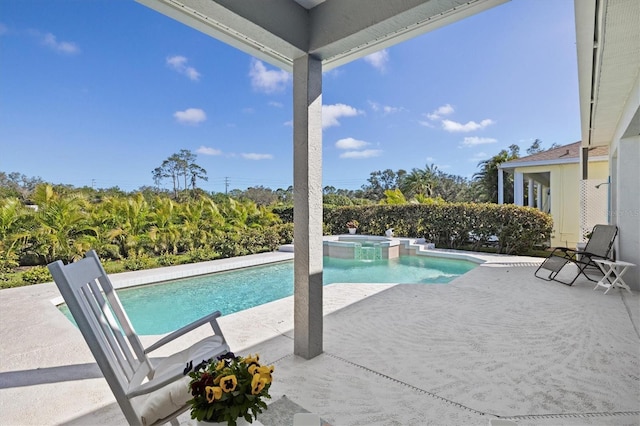 view of swimming pool featuring a pool with connected hot tub and a patio