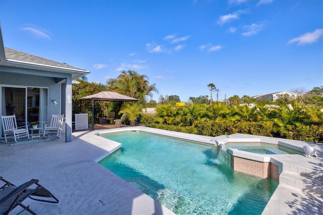 view of swimming pool featuring a pool with connected hot tub, a patio, and a gazebo