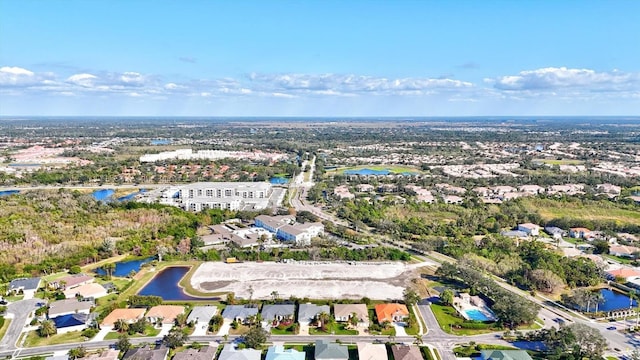 birds eye view of property with a water view and a residential view