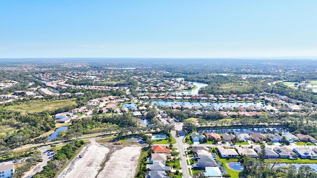 drone / aerial view with a residential view and a water view