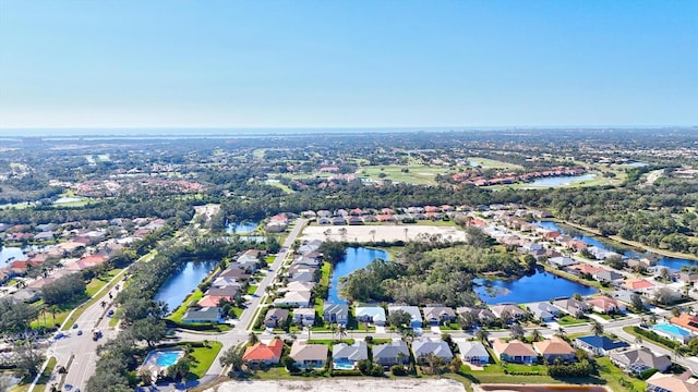 drone / aerial view featuring a water view and a residential view