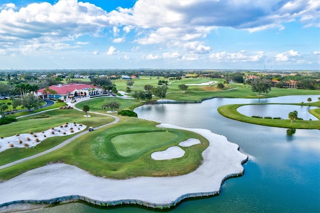 drone / aerial view with a water view and golf course view