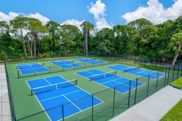 view of sport court featuring fence