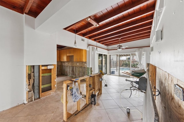 interior space featuring ceiling fan, vaulted ceiling with beams, light tile patterned floors, and wood ceiling