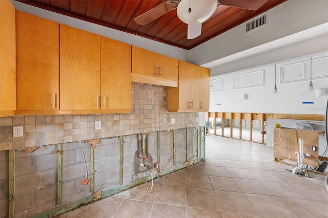 kitchen featuring tasteful backsplash, light tile patterned floors, wooden ceiling, and ceiling fan