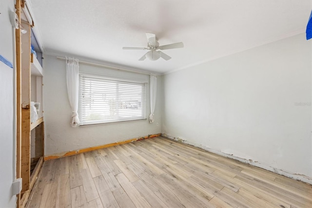 unfurnished bedroom with ceiling fan, ornamental molding, and light hardwood / wood-style flooring