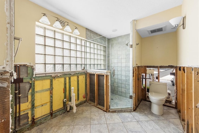 bathroom with tile patterned flooring, an enclosed shower, and toilet