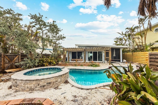 view of swimming pool with an in ground hot tub