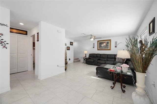 living room featuring light tile patterned floors and ceiling fan