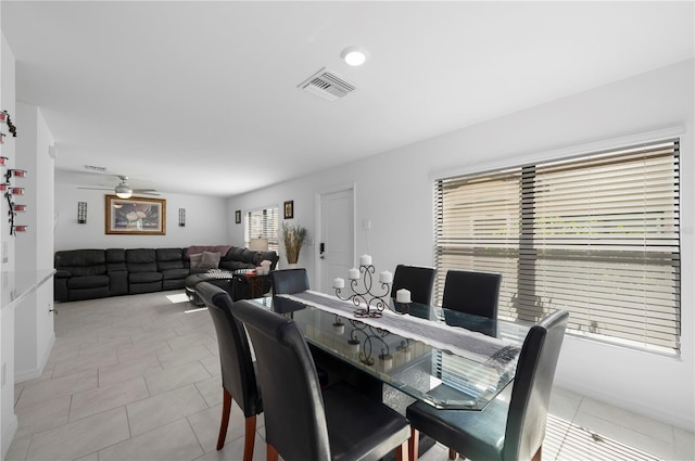 tiled dining room with ceiling fan