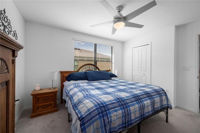 carpeted bedroom with ceiling fan and a closet