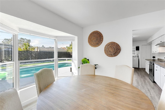 dining room featuring washer / clothes dryer and light hardwood / wood-style floors